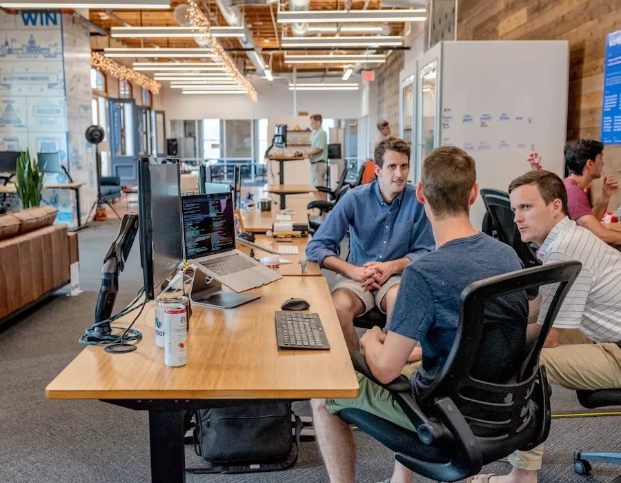 Startup team collaborating around a desk in a modern office